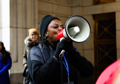 Person speaking into megaphone.